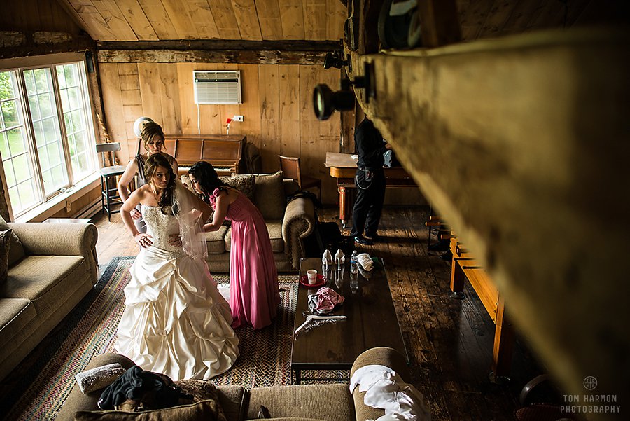 bride getting her dress on in the Crist Mill Playhouse
